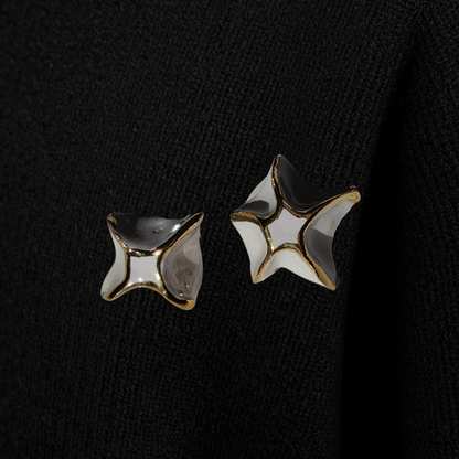 Star-shaped earrings on a black background