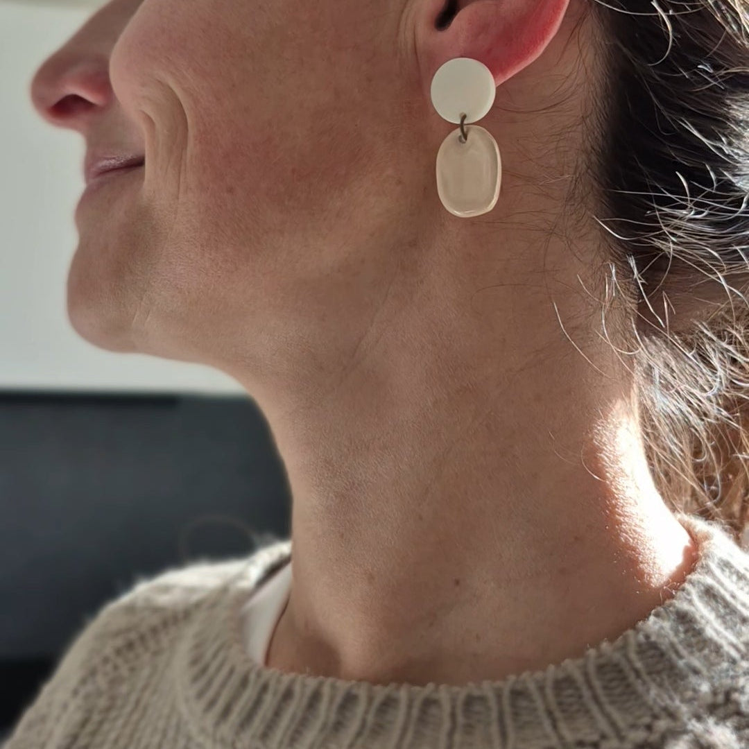 Close-up of a woman wearing earring indoors.