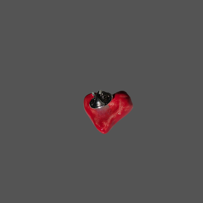 ceramic red heart-shaped pin on a gray background
