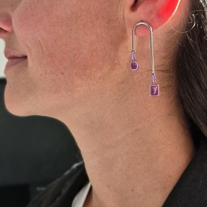 Close-up of a woman wearing a unique earring.